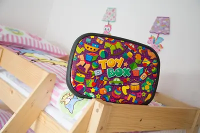 a toy box bag sitting on top of a bunk bed at Apartments Ema in Podčetrtek