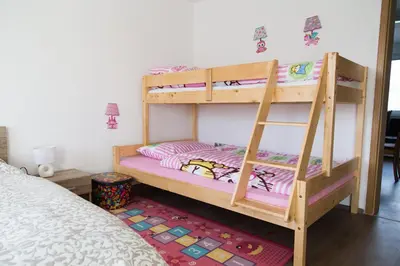 a bunk bed with two bunk beds in a room at Apartments Ema in Podčetrtek