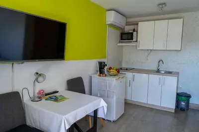 a small kitchen with a table and a small kitchen with a table and a table at Apartments Ema in Podčetrtek