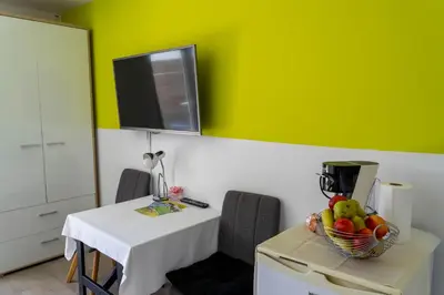 a room with a table with a bowl of fruit on it at Apartments Ema in Podčetrtek