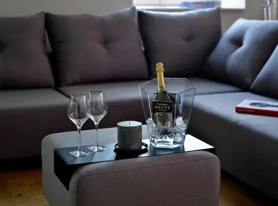 a bottle of wine and two wine glasses on a table at Hotel Maribor, City apartments in Maribor