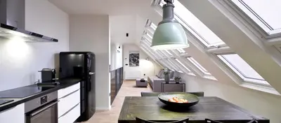 a kitchen with a table and some skylights at Hotel Maribor, City apartments in Maribor