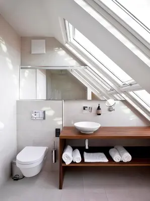 a bathroom with a sink and a toilet and a skylight at Hotel Maribor, City apartments in Maribor