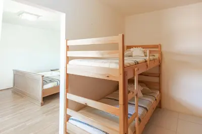 a bedroom with two bunk beds in a room at Villa HerMes ArT in Dutovlje