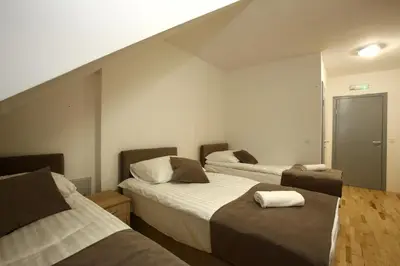 a hotel room with two beds and a staircase at Gostilna in prenočišča Gedžo in Novo Mesto