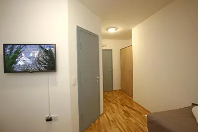a room with a bed and a television on a wall at Gostilna in prenočišča Gedžo in Novo Mesto