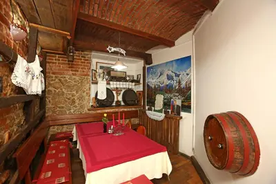 a dining room with a table and a wine barrel at Gostilna in prenočišča Gedžo in Novo Mesto