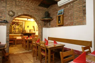 a restaurant with tables and chairs with red napkins on them at Gostilna in prenočišča Gedžo in Novo Mesto