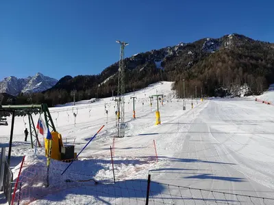 a snow covered ski slope with a ski lift at Apartment Maša in Kranjska Gora