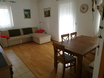 a living room with a table and a couch at Apartment Maša in Kranjska Gora