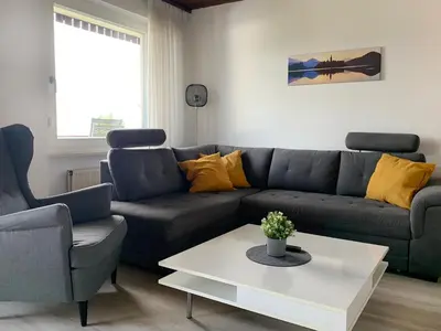 a living room with a couch and a table at Apartments Franc in Bled