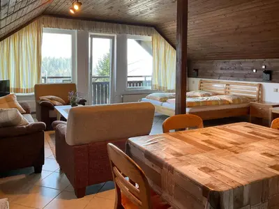 a room with a bed and a table and chairs at Apartments Franc in Bled