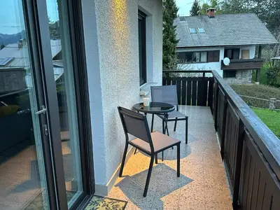 a patio with two chairs and a table on a balcony at Apartments Franc in Bled