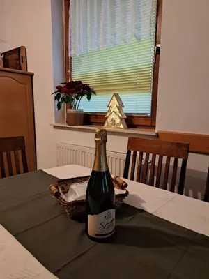 a bottle of wine sitting on top of a table at Apartma Smole in Kranjska Gora
