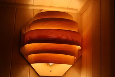 a large light fixture hanging from a wall at Chalet Encijan - Velika planina in Stahovica