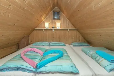 a bed with two pillows in the shape of hearts at Chalet Encijan - Velika planina in Stahovica