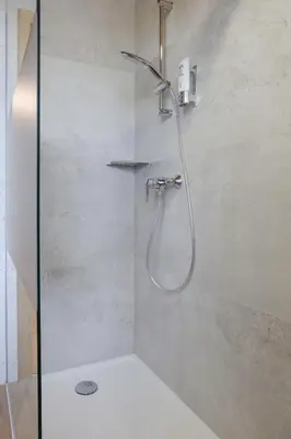 a shower with a shower head in a bathroom at Tourist farm Mulej in Bled