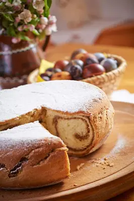 a plate with a loaf of bread and a basket of fruit at Apartma Lesjak - pobeg v naravo 2 in Šmihel nad Mozirjem