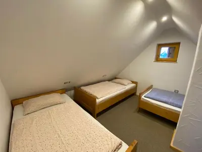 a room with two beds and a window at Chalet Košutnik Velika planina in Kamniška Bistrica