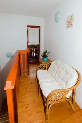 a living room with a white couch and a table at Thirsty River Apartments in Bovec