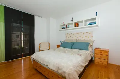 a bedroom with a bed and a chair in it at Thirsty River Apartments in Bovec