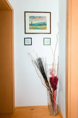 a vase with flowers in it on a table at Thirsty River Apartments in Bovec