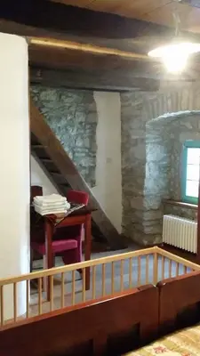 a room with a staircase with a table and a chair at Apartments Valentinus 1800 in Sežana