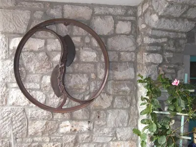 a mirror hanging on a brick wall with a plant at Apartments Valentinus 1800 in Sežana