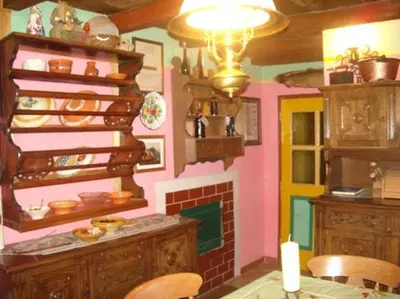 a kitchen with a fireplace and a dining room at Pri Macku in Tolmin