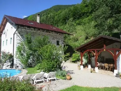 a house with a patio and a swimming pool at Pri Macku in Tolmin