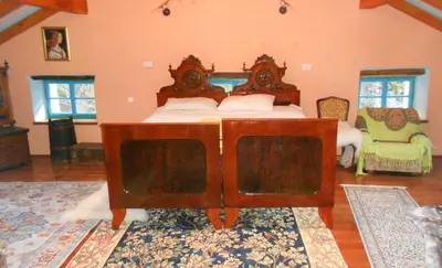 a bedroom with a wooden bed in a room at Pri Macku in Tolmin