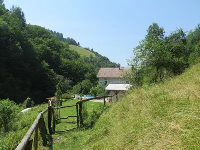 a house on the side of a hill with a fence at Pri Macku in Tolmin