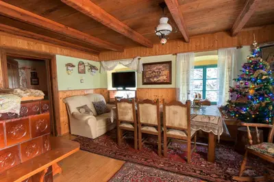 a living room with a christmas tree and a table at Pri Macku in Tolmin
