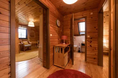 a room with wooden walls and wooden flooring in a cabin at Cosy Hill Home Rucman With a Breathtaking View in Zgornja Pohanca