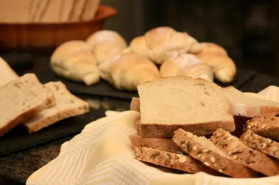 a pile of bread sitting on top of a table at PONI NAKLO - Sobe Marinšek in Naklo