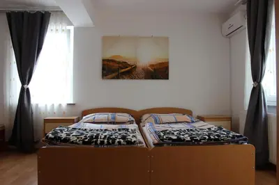 two twin beds in a room with a window at PONI NAKLO - Sobe Marinšek in Naklo