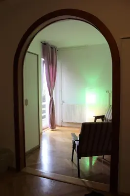 a living room with a couch and a mirror at PONI NAKLO - Sobe Marinšek in Naklo