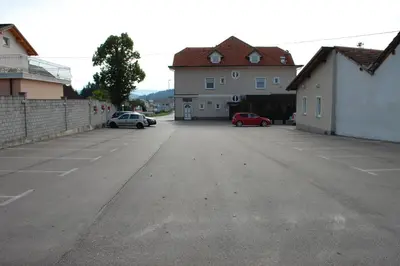 an empty parking lot with two cars parked in it at Guest House Goršič in Grosuplje
