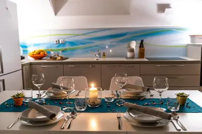 a kitchen with a table with a candle and glasses at Holiday Residence Ana in Boršt