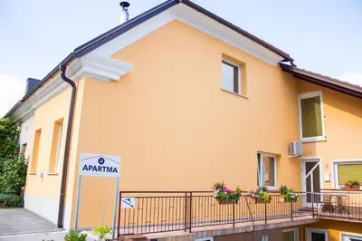 a yellow house with aania sign in front of it at Pri Neji in Postojna