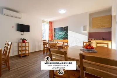 a kitchen and dining room with a table and chairs at Yapka Rooms in Tolmin