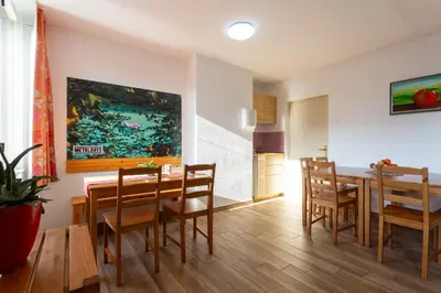 a kitchen and dining room with a table and chairs at Yapka Rooms in Tolmin