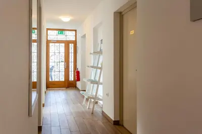 a hallway with a room with a door and a staircase at Yapka Rooms in Tolmin