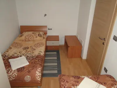 a small room with two beds and a staircase at Apartma Jezero in Most na Soči