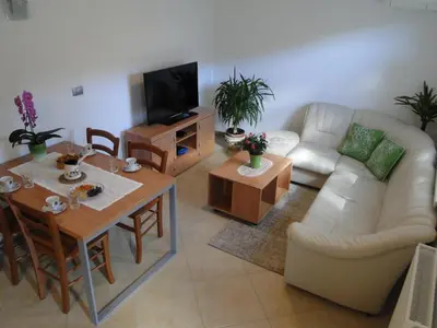 a living room with a couch and a table at Apartma Jezero in Most na Soči