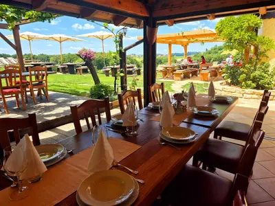 a wooden table with plates and napkins on it at Turistična Kmetija Puklavec in Zasavci