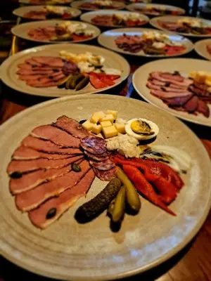 a table with plates of different types of food at Turistična Kmetija Puklavec in Zasavci