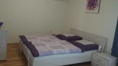 a bedroom with a large bed with two pillows at Apartma Rodica in Domžale