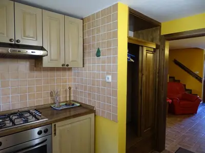 a kitchen with a sink and a stove top oven at Apartmaji Pr-Gujlu Sela nad Podmelcem 5220 TOLMIN in Podmelec