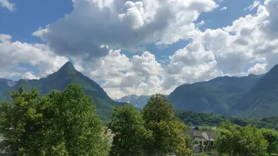 a group of trees with mountains in the background at Apartments Vila Bovec in Bovec
